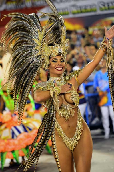 A reveler of Portela samba school performs during the first night of Carnival parade at the Sambadrome in Rio de Janeiro on February 11, 2013. AFP PHOTO / CHRISTOPHE SIMON